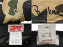 Load image into Gallery viewer, A Bathing ape アベイシングエイプ BAPE KAWS カウズ キャップ 帽子 1stCamo 日本製 コットン ベージュ カーキ 美品 中古 52530
